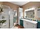 Bathroom with walk-in shower and teal vanity at 621 Sw 79Th Ct, Ocala, FL 34474