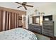 Serene bedroom with dresser, ceiling fan, and access to a second bathroom at 621 Sw 79Th Ct, Ocala, FL 34474
