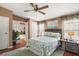 Comfortable bedroom with ensuite bathroom and ceiling fan at 621 Sw 79Th Ct, Ocala, FL 34474
