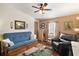 Common area with a futon, armchair, and ceiling fan at 621 Sw 79Th Ct, Ocala, FL 34474