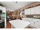 Bright kitchen with white cabinets, an island, and view into adjacent living area at 621 Sw 79Th Ct, Ocala, FL 34474