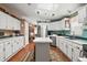 Kitchen with white cabinets, island, and skylights at 621 Sw 79Th Ct, Ocala, FL 34474
