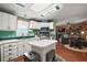 Bright kitchen with white cabinets and an island at 621 Sw 79Th Ct, Ocala, FL 34474