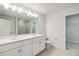 Double vanity bathroom with a large mirror and white cabinets at 6915 Five Oaks Dr, St Cloud, FL 34773