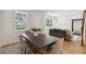 Modern dining area with dark wood table, light gray chairs, and a built-in bench at 6915 Five Oaks Dr, St Cloud, FL 34773
