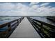 Wooden dock extending into the lake at Harmony at 6915 Five Oaks Dr, St Cloud, FL 34773