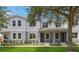 Two-story townhome with gray and white exterior, landscaping, and front porch at 6915 Five Oaks Dr, St Cloud, FL 34773