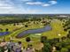 Aerial view of lush golf course with water features at 6915 Five Oaks Dr, St Cloud, FL 34773