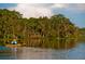 Person kayaking on calm lake, lush trees in background at 6915 Five Oaks Dr, St Cloud, FL 34773