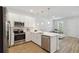 Modern kitchen with white cabinets and stainless steel appliances at 6915 Five Oaks Dr, St Cloud, FL 34773