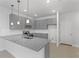 Modern kitchen with gray cabinets, granite counters, and island at 6915 Five Oaks Dr, St Cloud, FL 34773