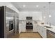 Modern kitchen with white cabinets and stainless steel appliances at 6915 Five Oaks Dr, Harmony, FL 34773