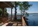 Peaceful lakeside view from a covered wooden platform at 6915 Five Oaks Dr, St Cloud, FL 34773