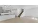Open living room with staircase and kitchen view at 6915 Five Oaks Dr, St Cloud, FL 34773