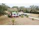 Aerial view of a two-story house with a large yard, pool, and outbuildings at 13660 Se 80Th Ave, Summerfield, FL 34491
