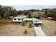 Aerial view of a two-story house with a carport and palm trees at 13660 Se 80Th Ave, Summerfield, FL 34491