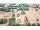 Wide shot of the property from above, showing the house and surrounding land at 13660 Se 80Th Ave, Summerfield, FL 34491