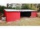 Red metal barn with open sides and wooden accents at 13660 Se 80Th Ave, Summerfield, FL 34491