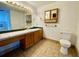 Bathroom with wood vanity, tiled floors, and a toilet at 13660 Se 80Th Ave, Summerfield, FL 34491