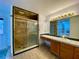 Bathroom boasts a shower, vanity, and a jetted tub at 13660 Se 80Th Ave, Summerfield, FL 34491