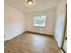 Bright bedroom with wood-look floors and a large window at 13660 Se 80Th Ave, Summerfield, FL 34491