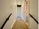 Upstairs hallway with light walls and dark railing at 13660 Se 80Th Ave, Summerfield, FL 34491