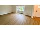 Bright living room featuring wood-look flooring and bay window at 13660 Se 80Th Ave, Summerfield, FL 34491