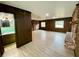 Spacious living area with wood-paneled walls and view of bathroom at 13660 Se 80Th Ave, Summerfield, FL 34491