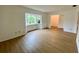 Living room with light walls, wood-look floors, and a bay window at 13660 Se 80Th Ave, Summerfield, FL 34491
