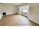 Spacious living room with new wood-look flooring and a bay window at 13660 Se 80Th Ave, Summerfield, FL 34491