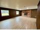 Large living room with brick fireplace and wood paneling at 13660 Se 80Th Ave, Summerfield, FL 34491
