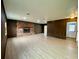 Spacious living room with brick fireplace and wood paneling at 13660 Se 80Th Ave, Summerfield, FL 34491