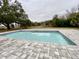 Inviting, refreshing blue pool with gray pavers at 13660 Se 80Th Ave, Summerfield, FL 34491