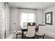 Bright dining area with a dark wood table and six off-white chairs at 1912 Quail Fields Cir, Winter Haven, FL 33884