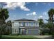 Two-story house with gray siding, two-car garage, and landscaping at 1912 Quail Fields Cir, Winter Haven, FL 33884