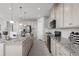 Open concept kitchen with granite countertops and stainless steel appliances at 1912 Quail Fields Cir, Winter Haven, FL 33884