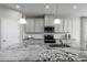 Kitchen island with granite countertop and stainless steel sink at 1912 Quail Fields Cir, Winter Haven, FL 33884