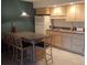 Kitchen features light wood cabinets and a breakfast bar at 3700 S Atlantic Ave # 405, New Smyrna Beach, FL 32169
