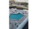 Community pool with surrounding patio furniture at 3700 S Atlantic Ave # 405, New Smyrna Beach, FL 32169