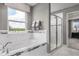 Relaxing bathroom with soaking tub, shower, and marble tile at 3785 Voyageurs Ct, Apopka, FL 32712
