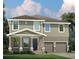 Two-story home with gray siding, stone accents, and a two-car garage at 3785 Voyageurs Ct, Apopka, FL 32712