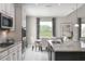 Kitchen with granite countertops, white cabinets, and eat-in area at 3785 Voyageurs Ct, Apopka, FL 32712