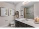 Bathroom features a dark vanity with a white countertop, and a tiled shower with glass door at 3786 Sky Mountain Aly, Apopka, FL 32712