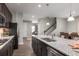 Modern kitchen features a granite countertop island, stainless steel appliances and dark cabinets at 3786 Sky Mountain Aly, Apopka, FL 32712