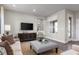 Modern living room featuring stylish furniture, neutral tones, and lots of natural light from a window at 3786 Sky Mountain Aly, Apopka, FL 32712