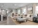 Well-lit living area with a staircase, open layout, and stylish furniture creating a cozy atmosphere at 3786 Sky Mountain Aly, Apopka, FL 32712