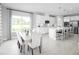 Bright dining room with white table and chairs, overlooking backyard at 7427 Sw 108Th St, Ocala, FL 34476