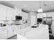 Modern kitchen with white cabinets, quartz countertops, and stainless steel appliances at 7427 Sw 108Th St, Ocala, FL 34476