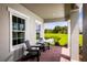 Peaceful porch overlooking a pond and green space at 7427 Sw 108Th St, Ocala, FL 34476