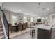 Kitchen and dining area with granite island and wicker dining chairs at 3744 Sky Mountain Aly, Apopka, FL 32712